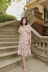 a lady in  a pink floral printed midi dress